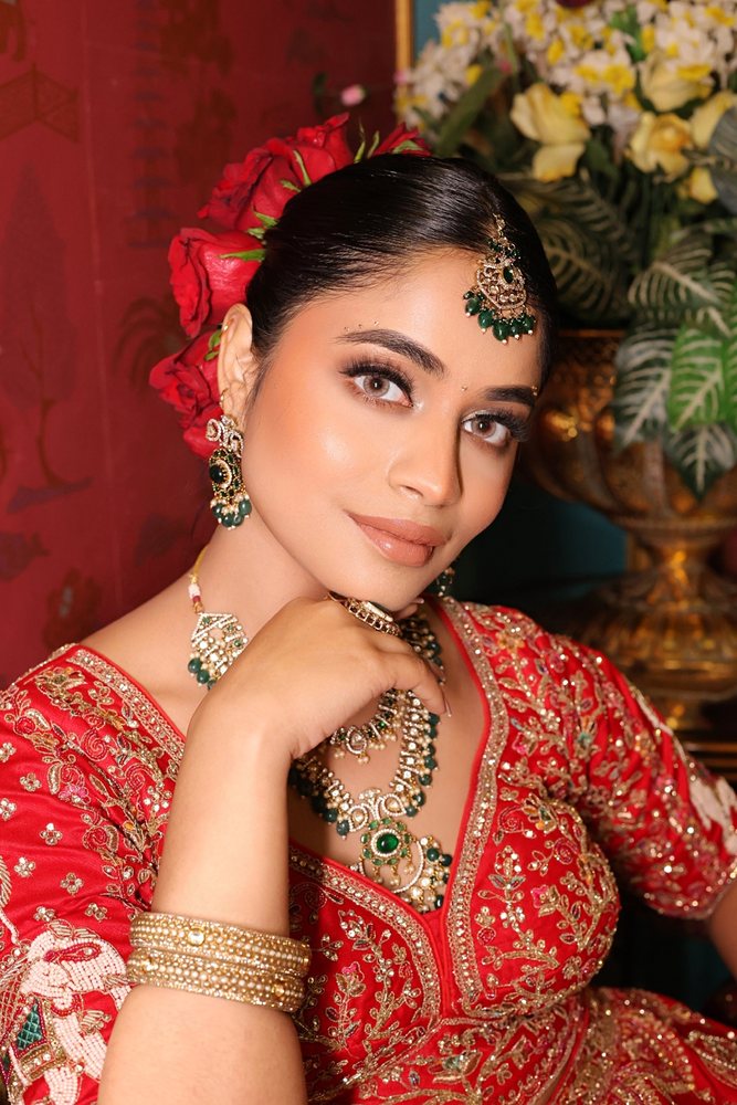 Soft glam bridal — red lehenga, floral hair