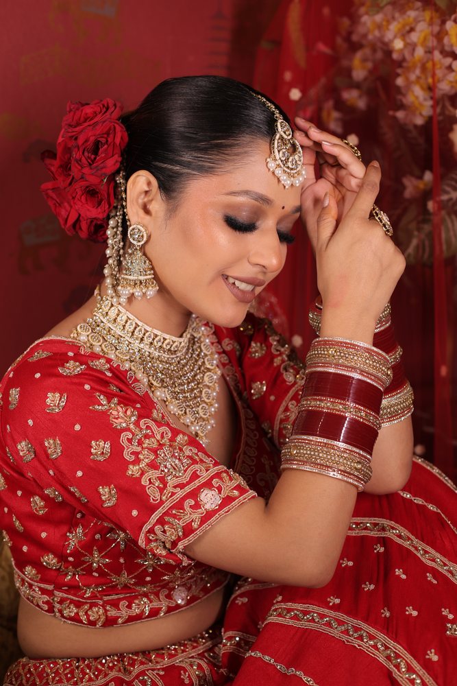 Bridal — red lehenga, red roses, pearl jhumkas
